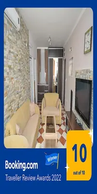 a living room with a couch and a tv at D&D Apartment 1 in Budva