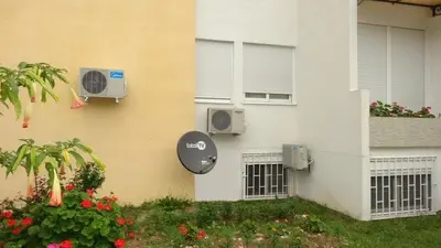 a building with two air conditioners on the side of it at D&D Apartment 1 in Budva