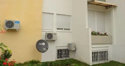 a building with two air conditioners on the side of it at D&D Apartment 1 in Budva