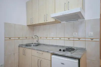 a kitchen with a sink and a stove at D&D Apartments 3 in Budva
