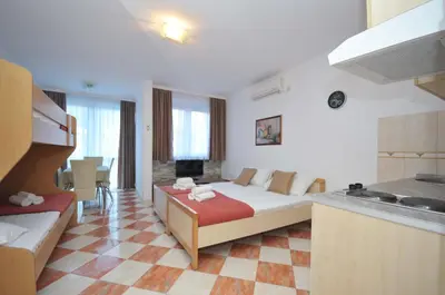 a living room with a bed and a kitchen at D&D Apartments 3 in Budva