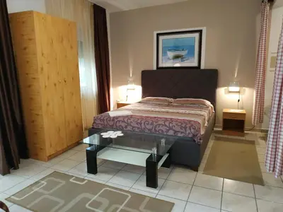 a bedroom with a bed and a glass table at Villa Marija Ulcinj in Ulcinj