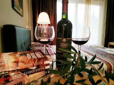 a bottle of wine and two glasses on a table at Villa Marija Ulcinj in Ulcinj