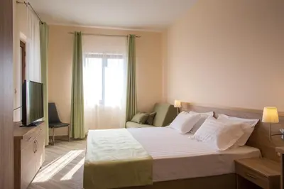 a hotel room with a bed and a television at ApartHotel Belvedere Residence Becici Budva in Budva