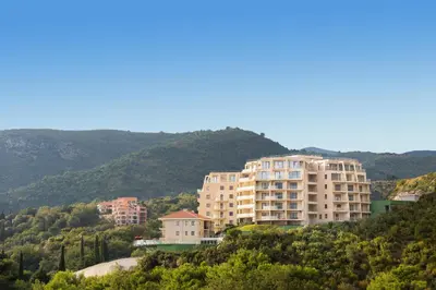 a group of buildings on top of a hill at ApartHotel Belvedere Residence Becici Budva in Budva