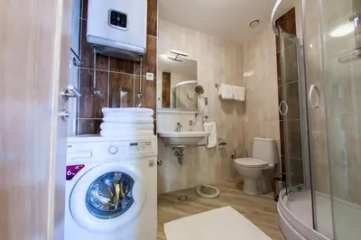 a bathroom with a washing machine and a toilet at ApartHotel Belvedere Residence Becici Budva in Budva