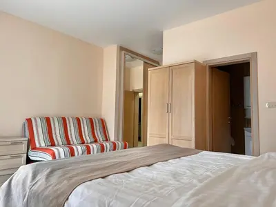 a bedroom with a bed and a chair at ApartHotel Belvedere Residence Becici Budva in Budva