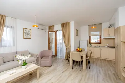 a living room with a couch and a table at Arvala Apartments in Budva