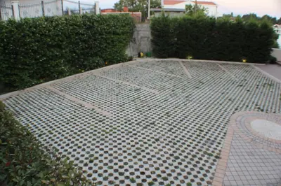 a metal grate on the ground in a yard at Apartments Kan in Ulcinj