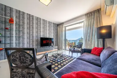 a living room with a couch and a tv at Apt 