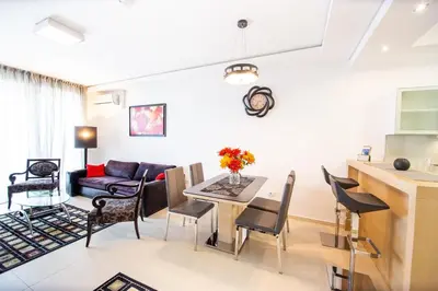 a living room and kitchen with a table and chairs at Apt 