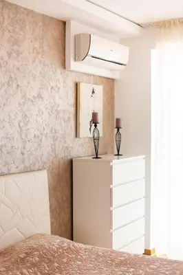 a bedroom with a bed and a dresser at Apt 