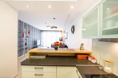 a kitchen with a table in the middle of it at Apt 