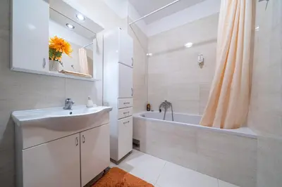 a bathroom with a sink and a tub and a shower at Apt 