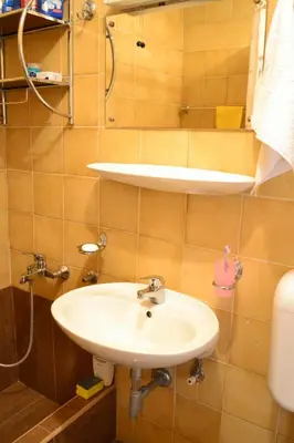 a bathroom with a sink and a toilet at Apartment Matea in Petrovac na Moru