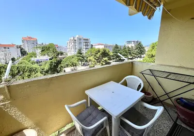 a white table and chairs on a balcony with a view at Albatros Apartments in Bar