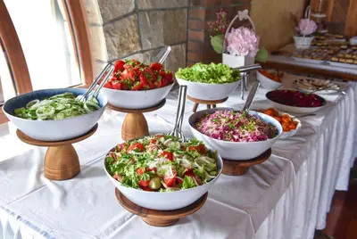 a buffet of bowls of salad on a table at Hotel Galeb in Čanj