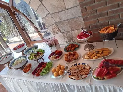 a table with many plates of food on it at Hotel Galeb in Čanj