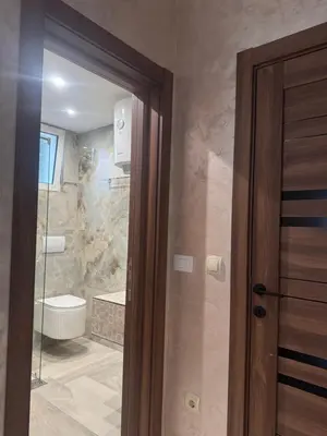 a bathroom with a shower and a glass door at Hotel Galeb in Čanj