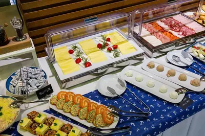 a buffet with different types of food on a table at Hotel Riva by Aycon in Petrovac na Moru