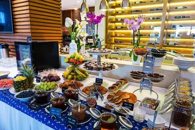a buffet of food on a table with desserts at Hotel Riva by Aycon in Petrovac na Moru