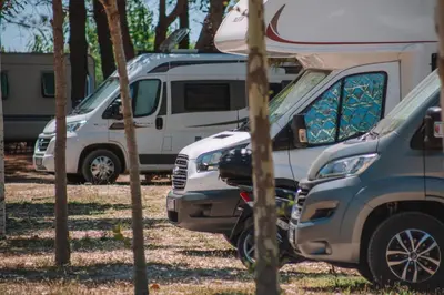 a row of parked vehicles with a camper at MCM Camping in Ulcinj