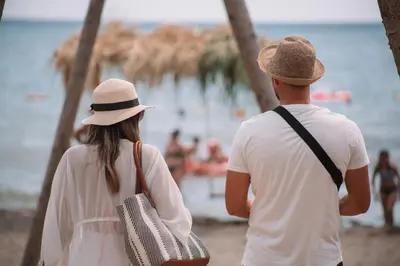 a man and a woman walking along the beach at MCM Camping in Ulcinj
