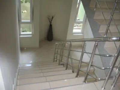 a staircase in a house with a glass railing at Guest House Vila Mimoza in Ulcinj