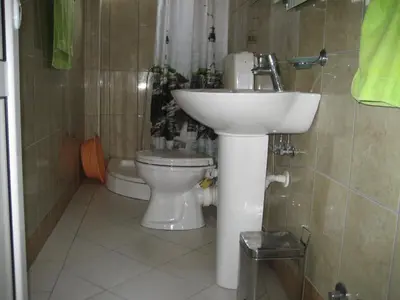 a bathroom with a sink and a toilet at Guest House Vila Mimoza in Ulcinj