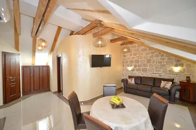 a living room with a table and a couch at Palazzo Max and Alex Apartments in Kotor