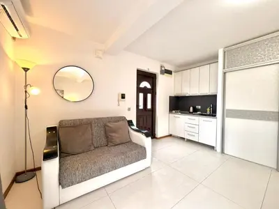 a living room with a couch and a kitchen at Apartments Villa Stefan in Budva