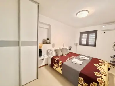 a bedroom with a bed and a mirror at Apartments Villa Stefan in Budva