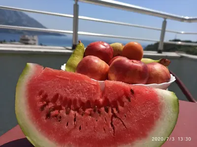 a bowl of fruit on a table with a watermelon at Apartments Mitende in Budva