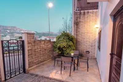 a patio with a table and chairs on a balcony at Bologna Apartments in Budva