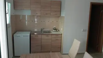 a small kitchen with a sink and a washer at Apartments 3ADE in Ulcinj