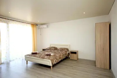 a bedroom with a bed and a large window at Apartments Victoria in Sutomore