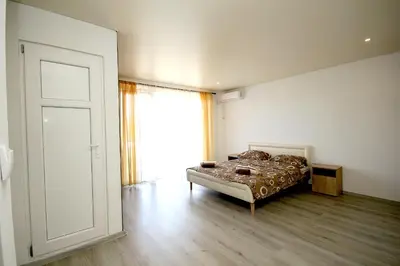 a bedroom with a bed and a large window at Apartments Victoria in Sutomore