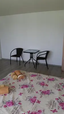 a bed in a room with a table and chairs at Apartments Victoria in Sutomore