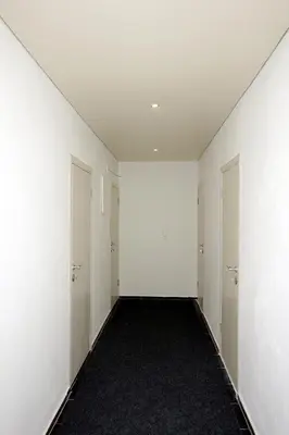 an empty hallway with white walls and doors at Apartments Victoria in Sutomore
