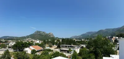 a view of a city with mountains in the background at Apartments Victoria in Sutomore