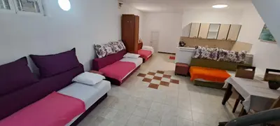 a living room with several couches and a table at Apartments and Rooms Villa Gaga 3 in Budva