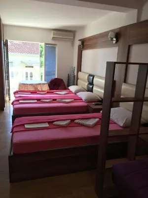 a room with three bunk beds and a window at Apartments and Rooms Villa Gaga 3 in Budva