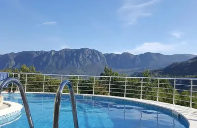 a swimming pool with a view of the mountains at Yokana Villa & Pool in Virpazar