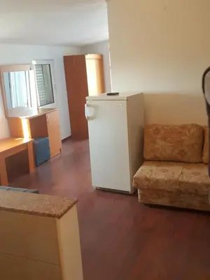 a living room with a refrigerator and a couch at Buljarica Bay Apartments in Petrovac na Moru