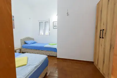 a small room with two beds and a door at Vila Vujošević in Utjeha