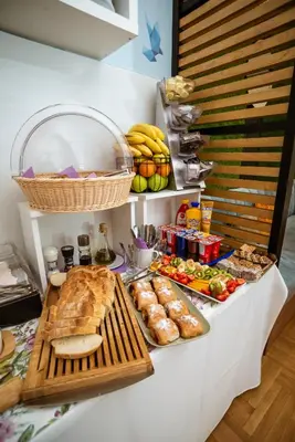 a buffet with bread and other food on a table at Peace 2 Apartments with parking in Budva