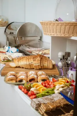 a bunch of different types of bread and vegetables on a counter at Peace 2 Apartments with parking in Budva