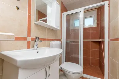 a bathroom with a sink and a toilet at Apartment Carpe Diem 1 in Utjeha