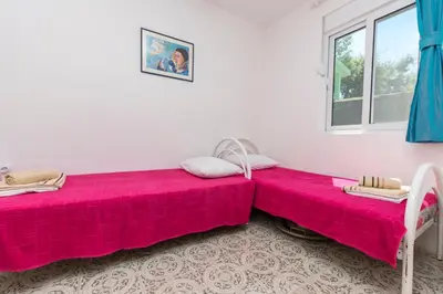 two beds sitting next to each other in a room at Apartment Carpe Diem 1 in Utjeha