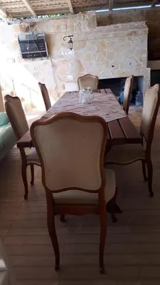 a dining room table with chairs and a tablecloth on it at Apartment Carpe Diem 1 in Utjeha